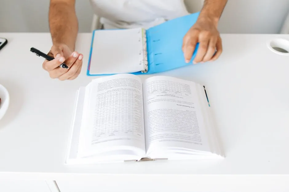 Organized Desk With Open Binder And Pens For Budget Planning